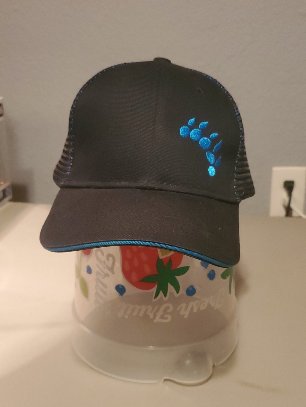 Black Trucker Hat with Teal Paw Accent